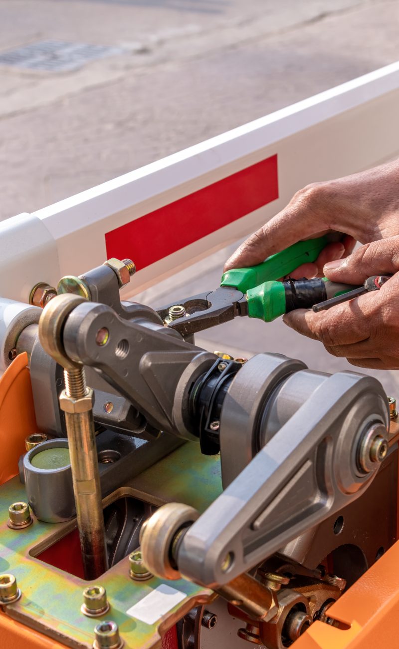 close-up-technician-assemble-barrier-gate-automati-2025-03-15-02-49-33-utc