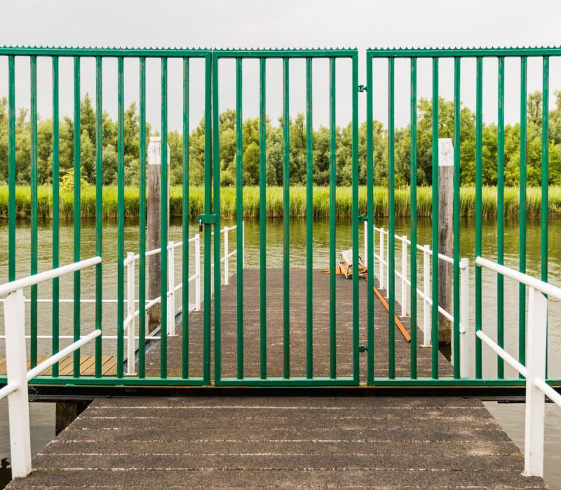 green-painted-steel-gate-on-a-jetty-sealed-with-a-2025-10-13-05-05-41-utc
