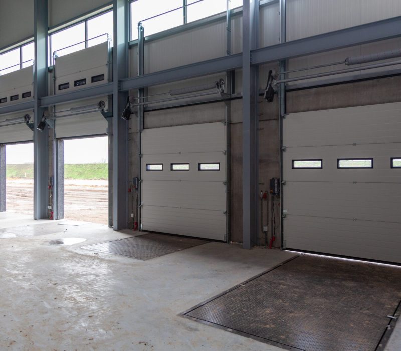 A row of loading bays in a warehouse with open and closed doors