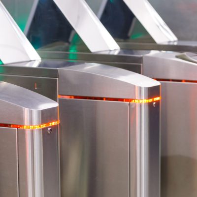 Close up of modern turnstiles for the passage of subway trains transport/ railway station, inside. Entrance in metro with electronic card access.