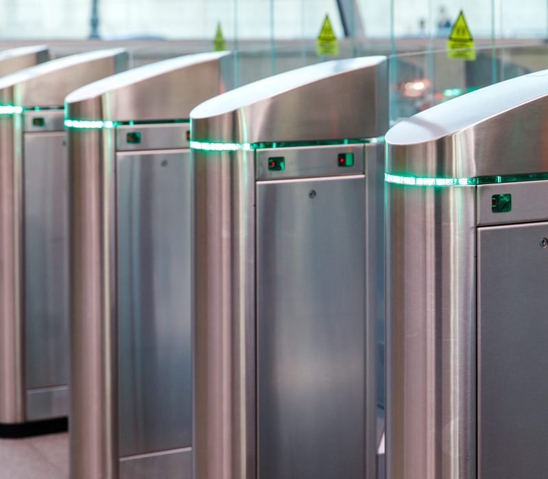 Close up of modern turnstiles for the passage of subway trains transport/ railway station, inside. Entrance in metro with electronic card access.